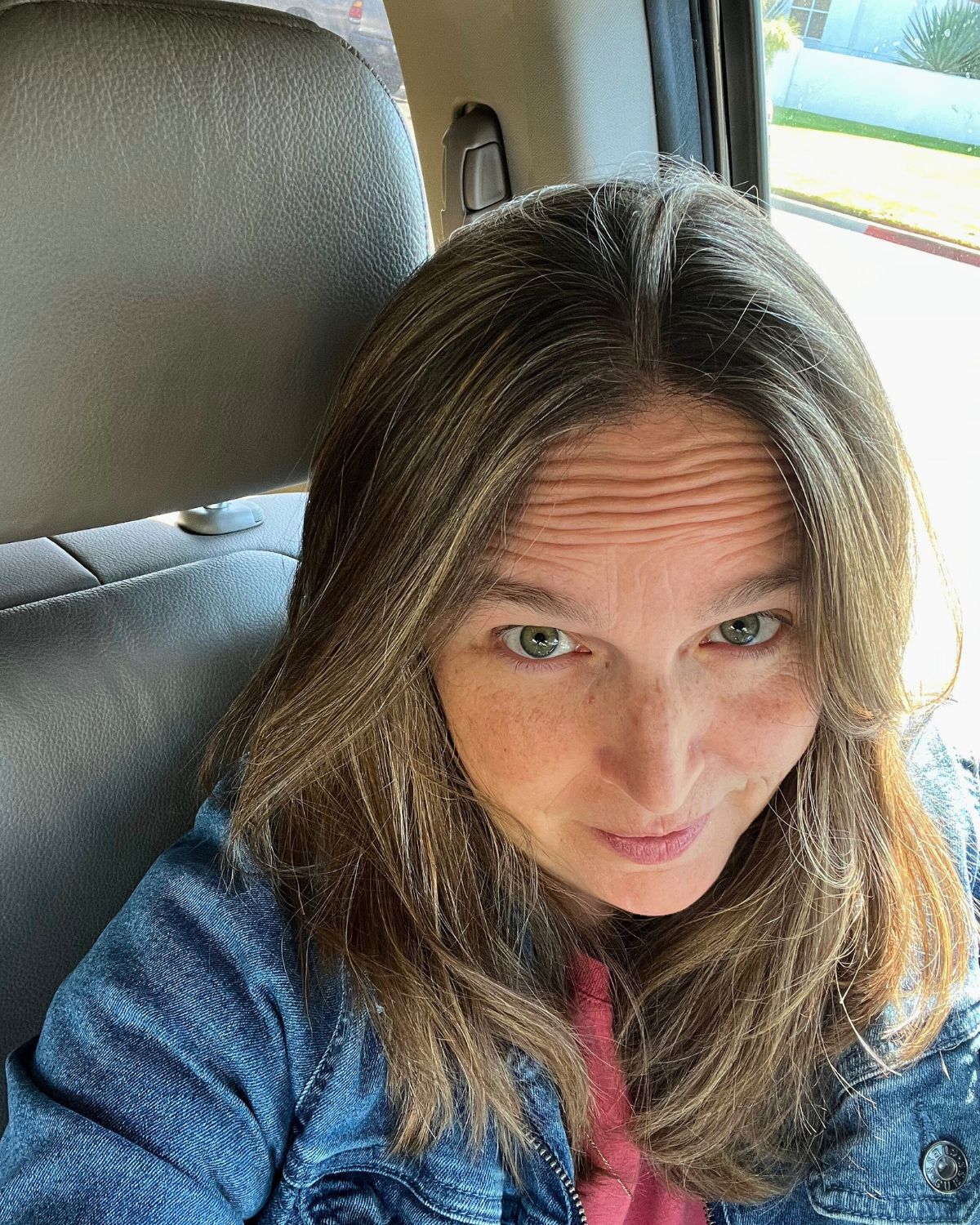 jessica in the car looking up at the camera.