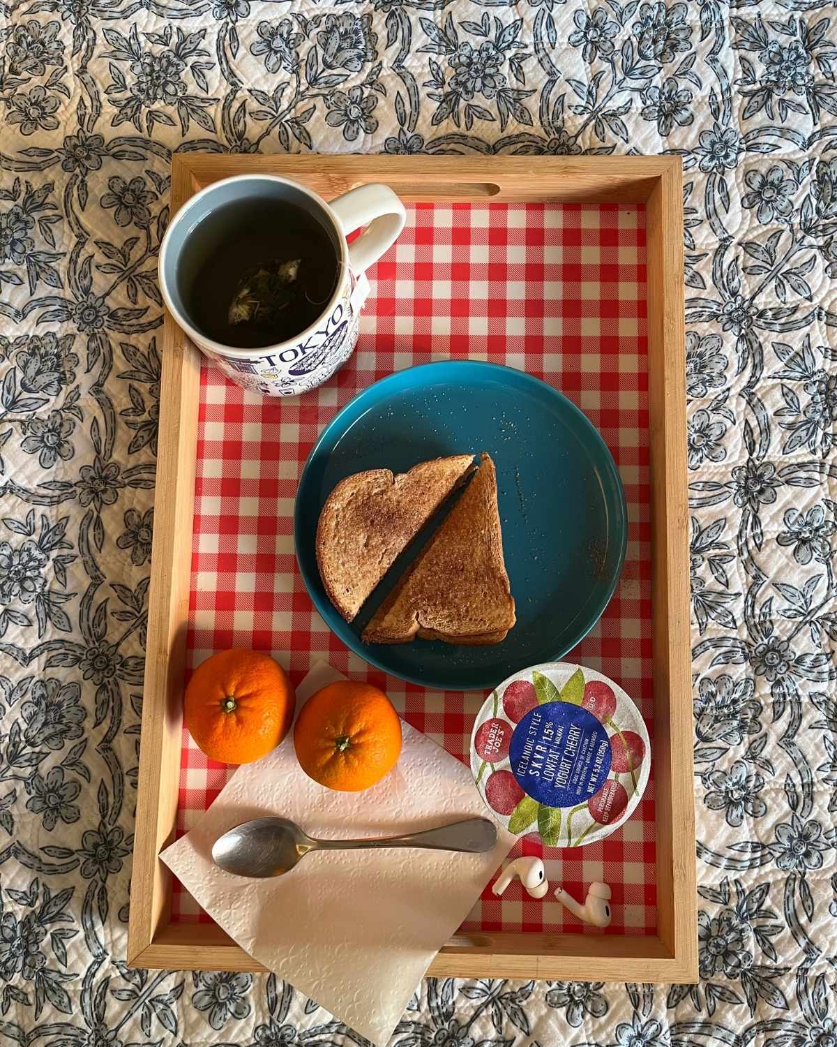 breakfast tray on quilt on bed.