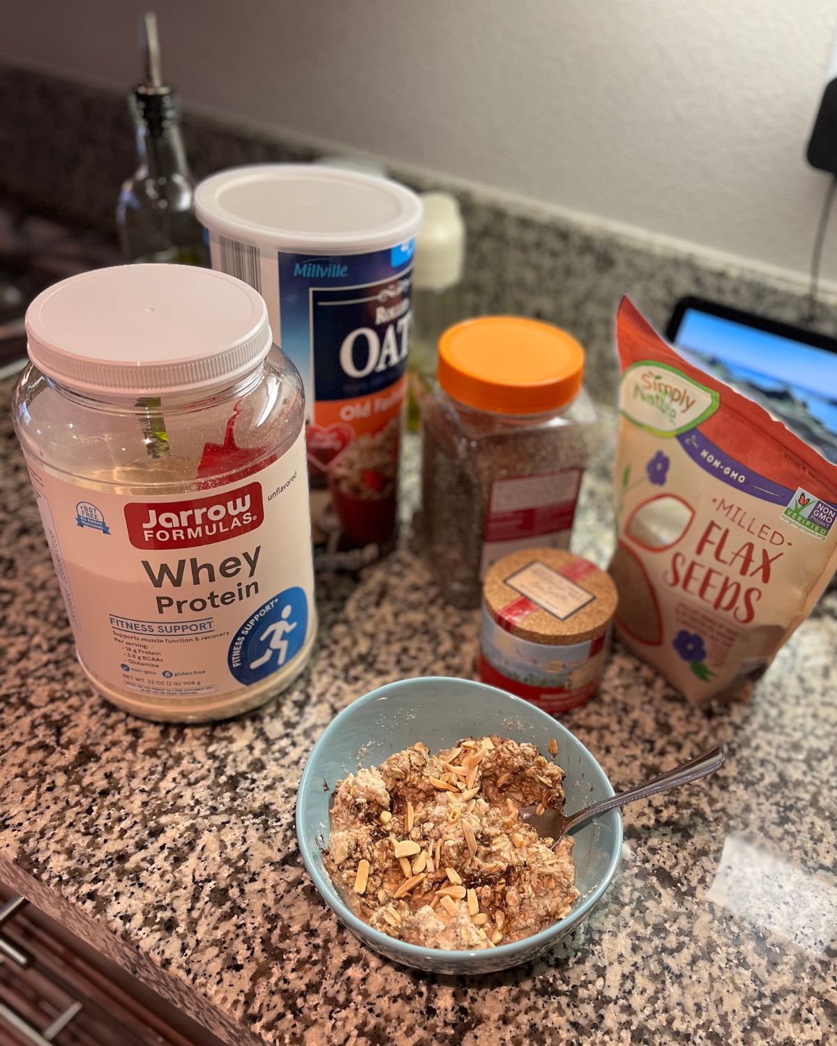 bowl of protein oats and all the ingredients to make it.