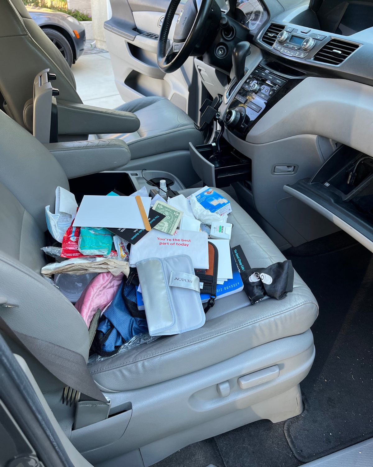 clutter from van console laid out on the seat.