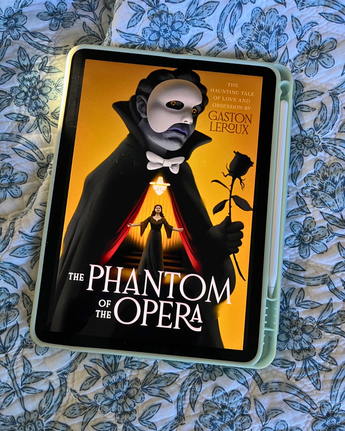cover image of phantom of the opera on iPad atop a flowered bedspread.