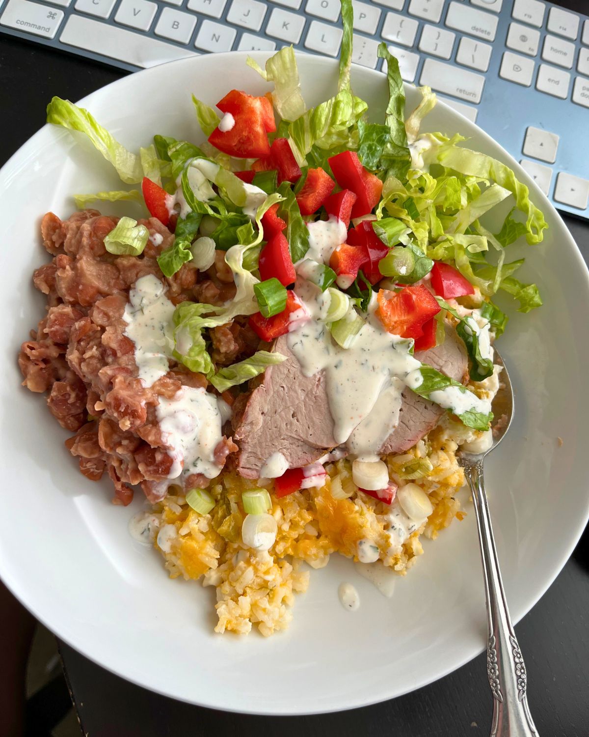 leftovers of green chile rice, beans, pork tenderloin and toppings.