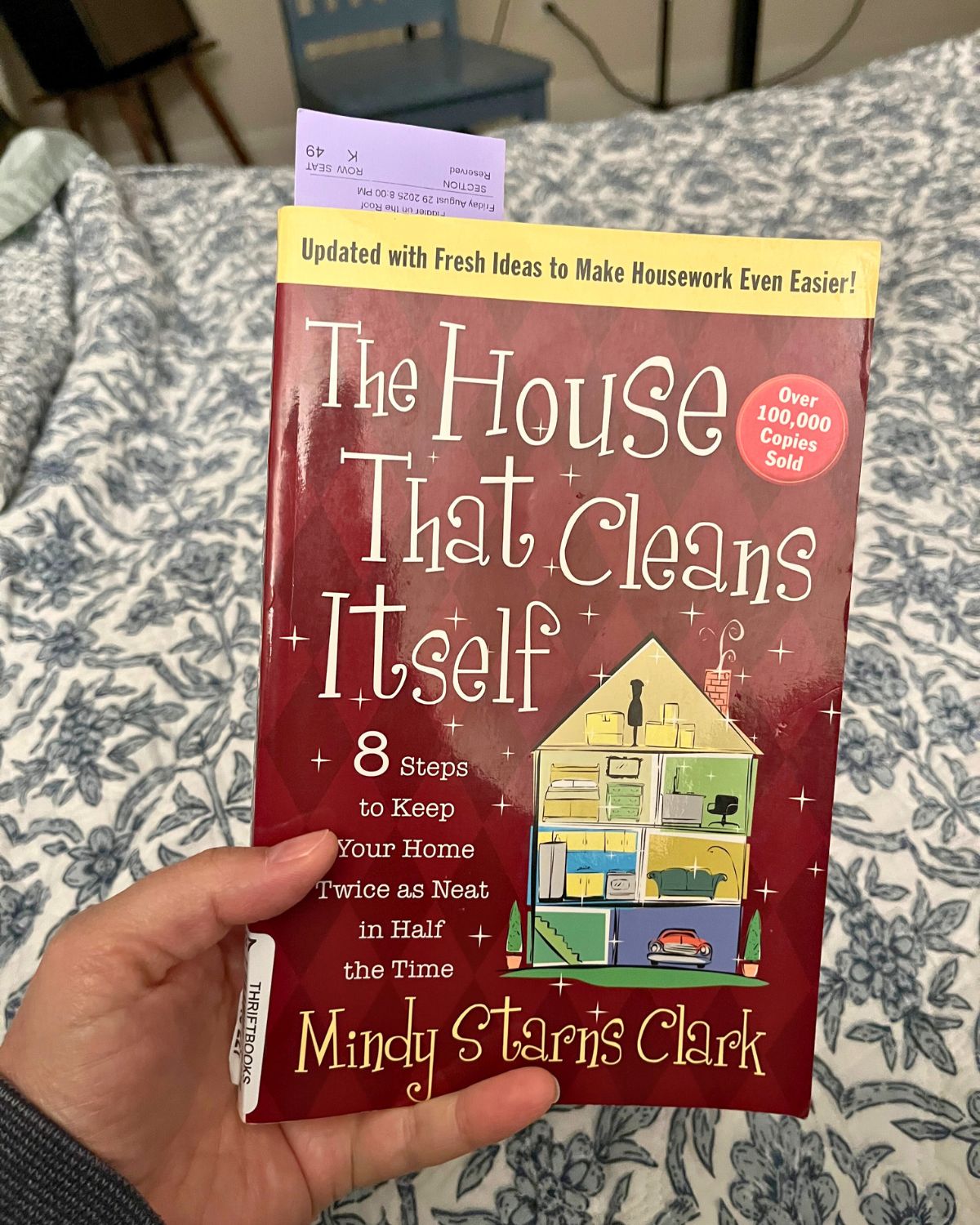 holding a copy of the house that cleans itself.