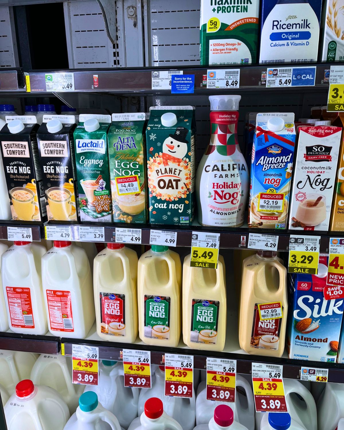 array of egg nog on sale at grocery store.