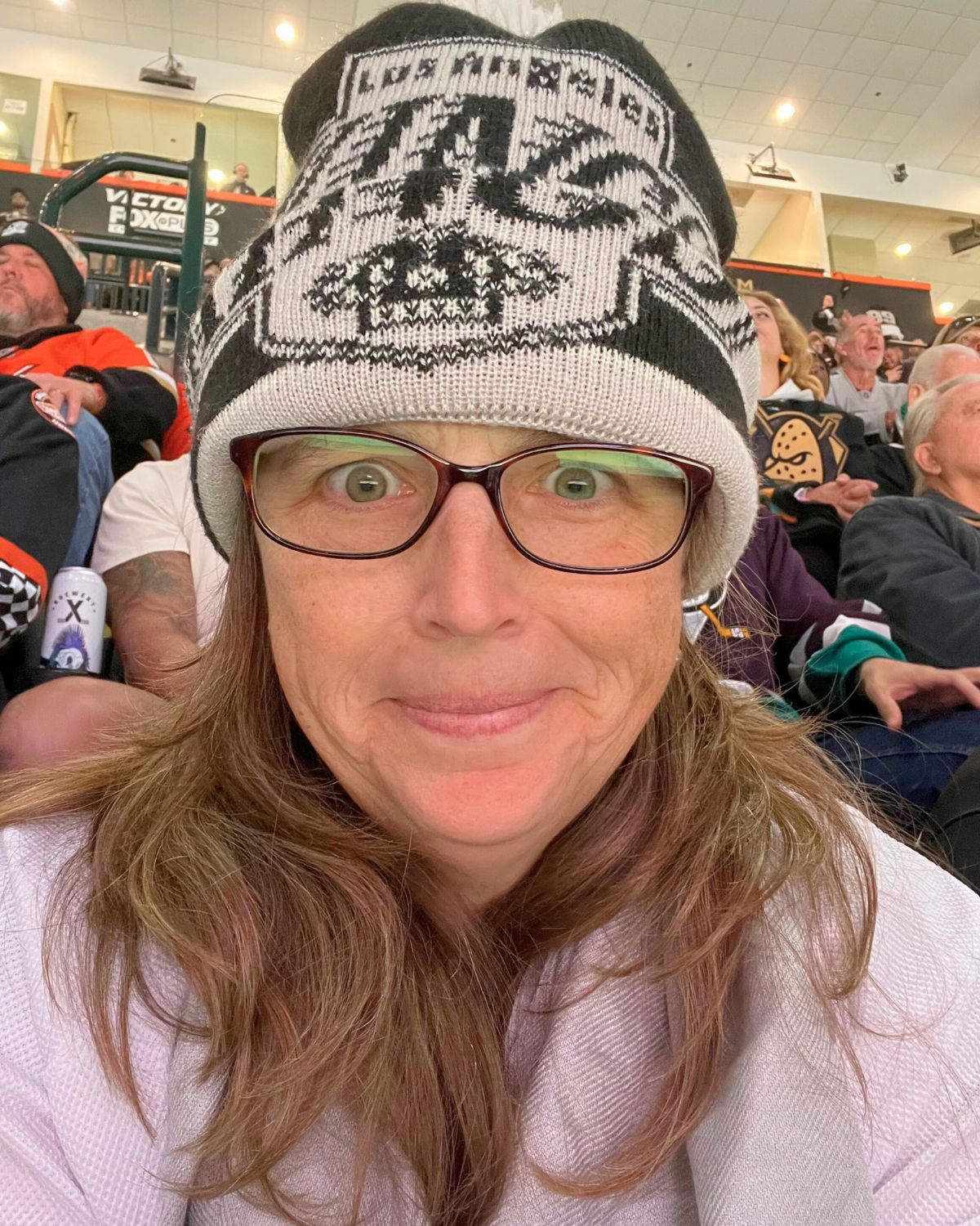 jessica in glasses and kings hat and jersey.