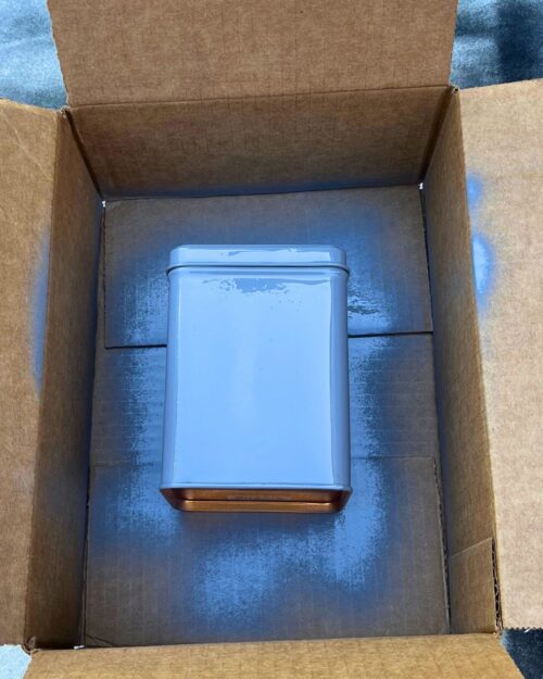 primed tea tin in cardboard box.
