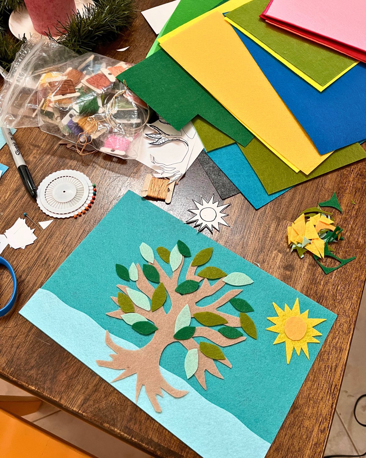 felt crafting strewn around the table.