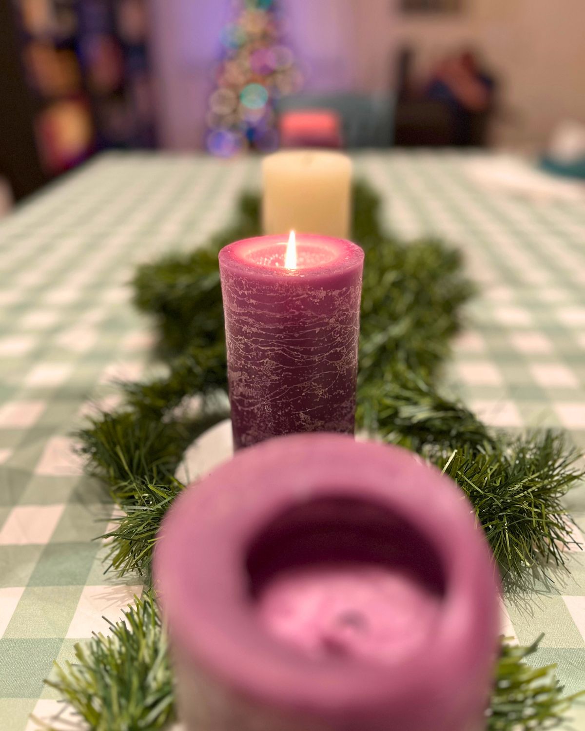 hope candle lit at holiday table.
