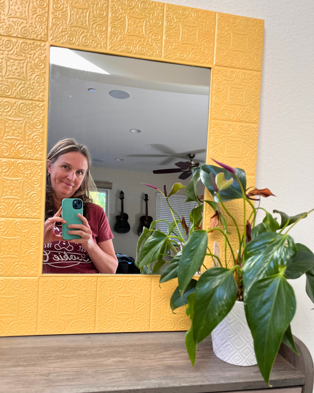 jessica looking in mirror holding camera.