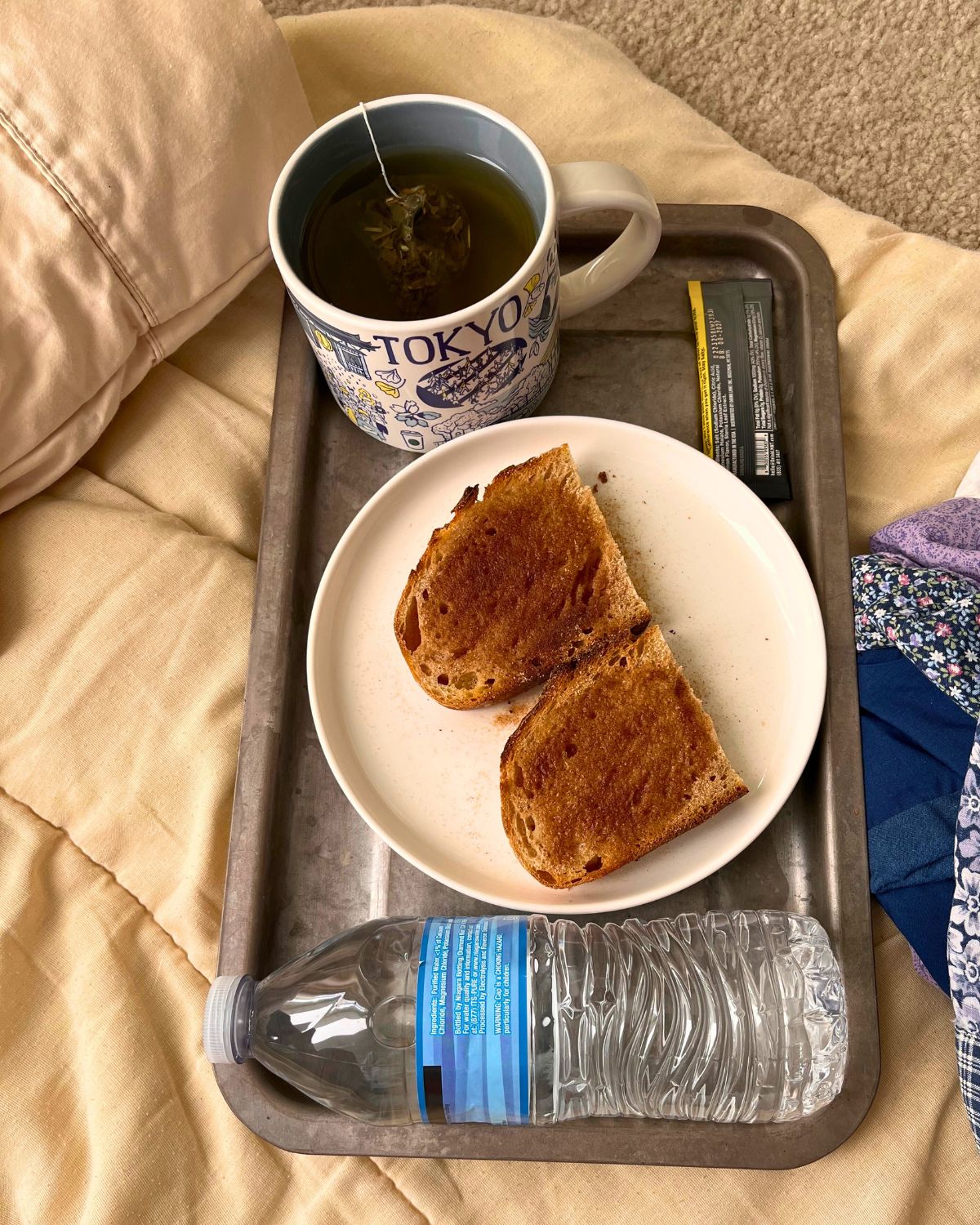 tray of cinnamon toast with water, electrolytes, and tea.