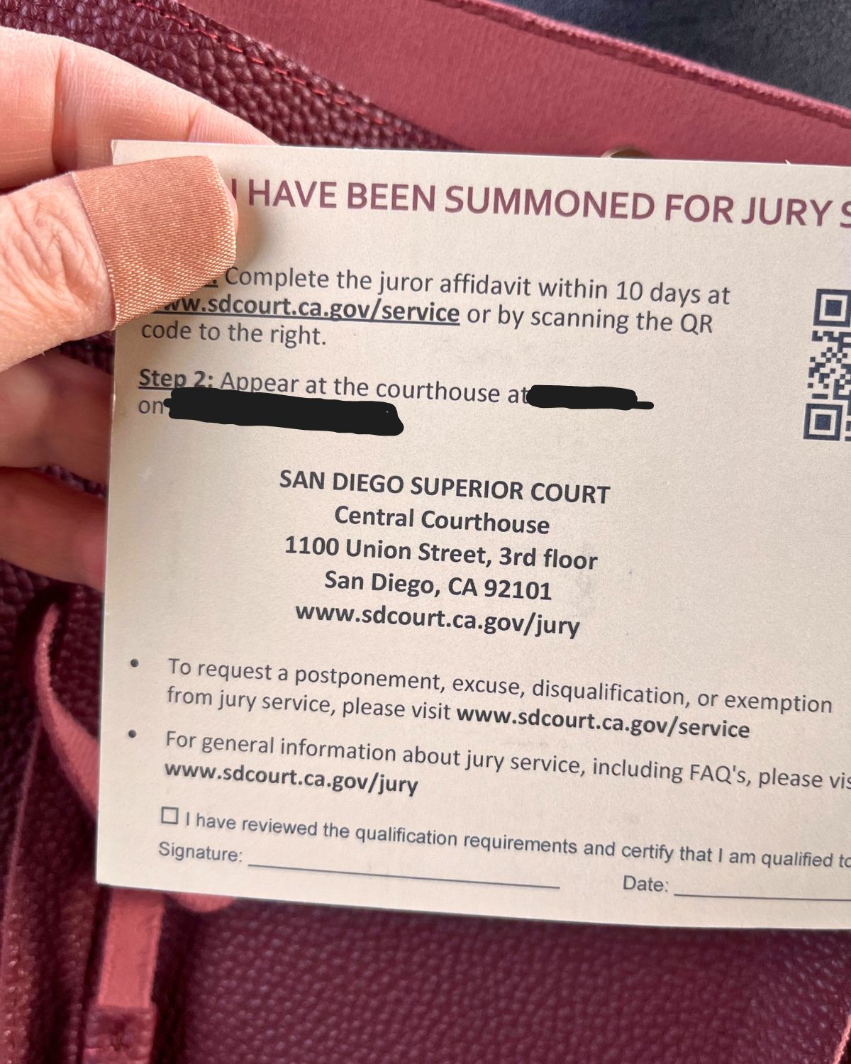 holding jury duty summons in hand.