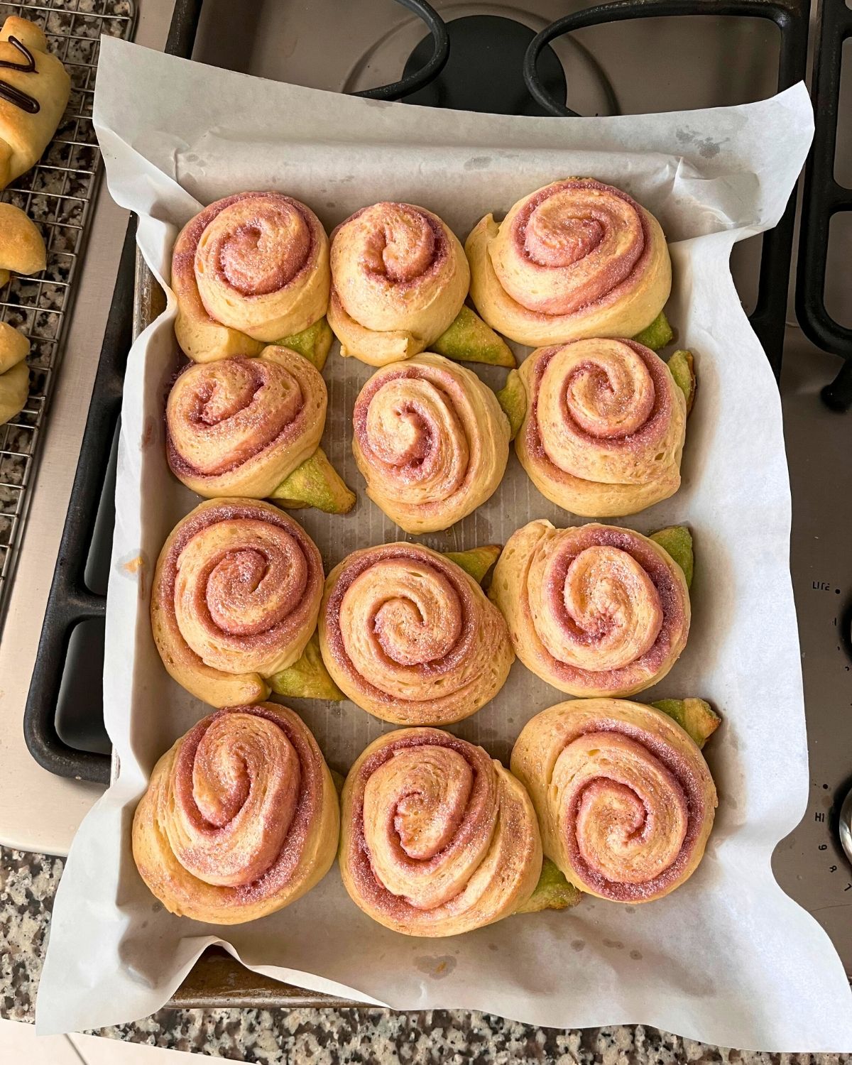 pan full of spring sweet rolls shaped liked roses.
