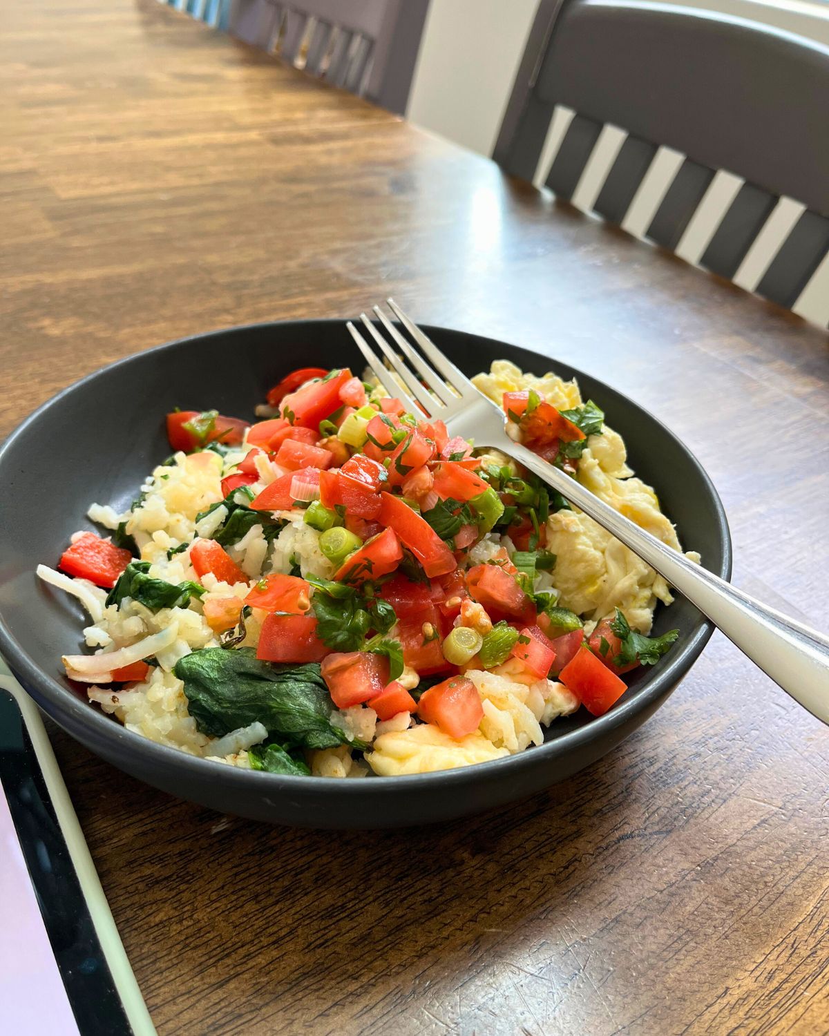 veggie forward breakfast in black dish.