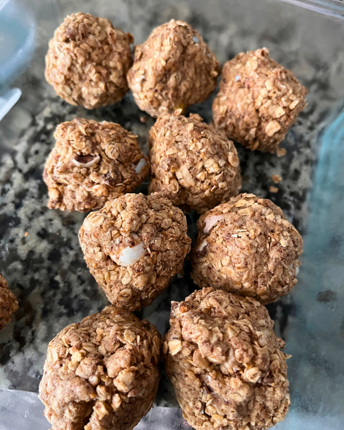 cadbury energy bites in glass dish on granite countertop.