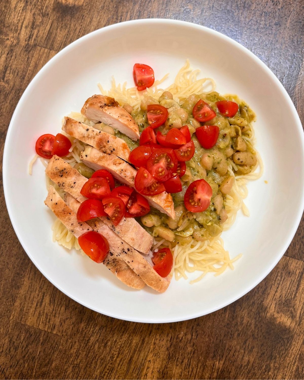 pesto beans and pasta with grilled chicken and tomatoes.