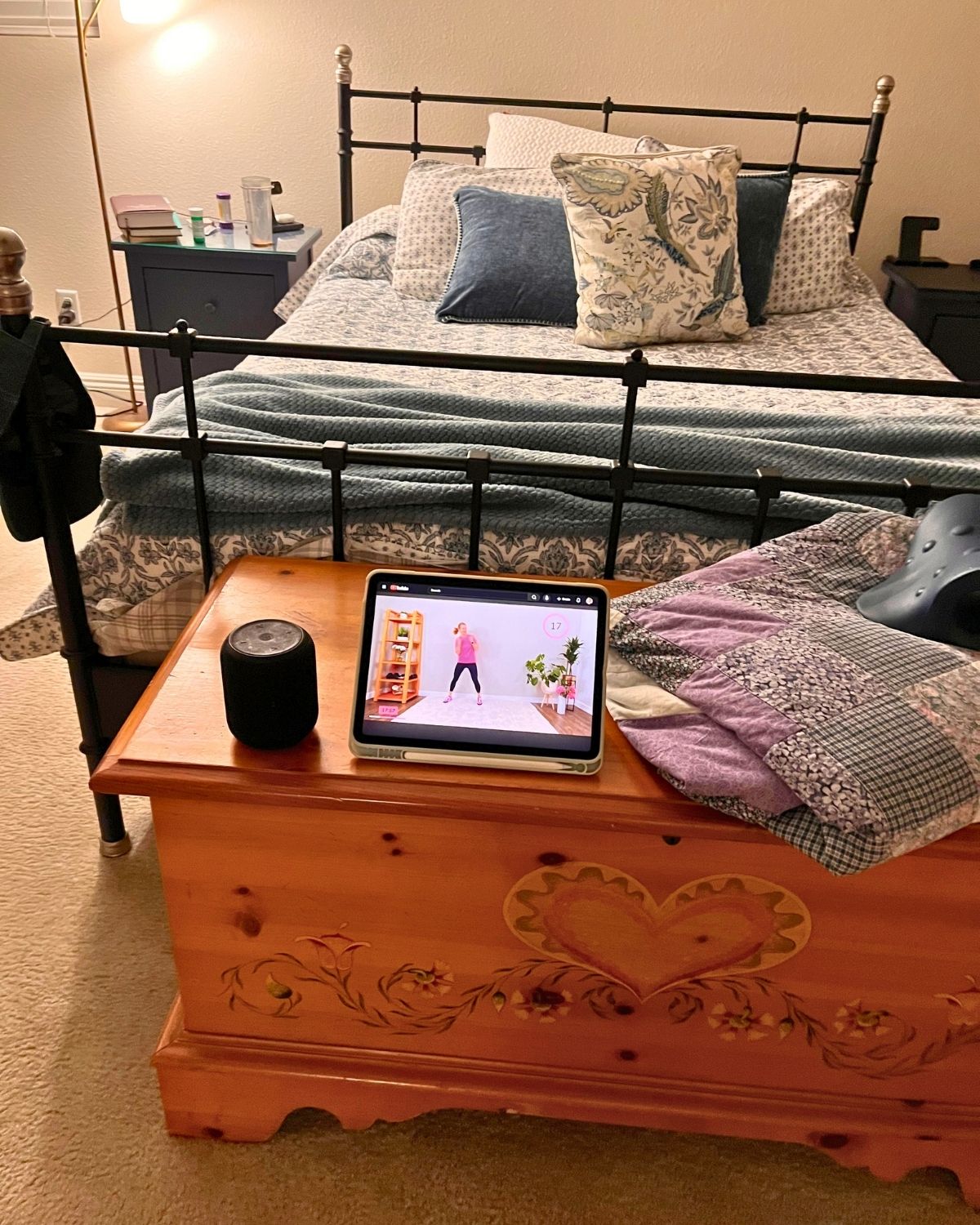 exercise video on iPad on hope chest next to portable speaker and a quilt.