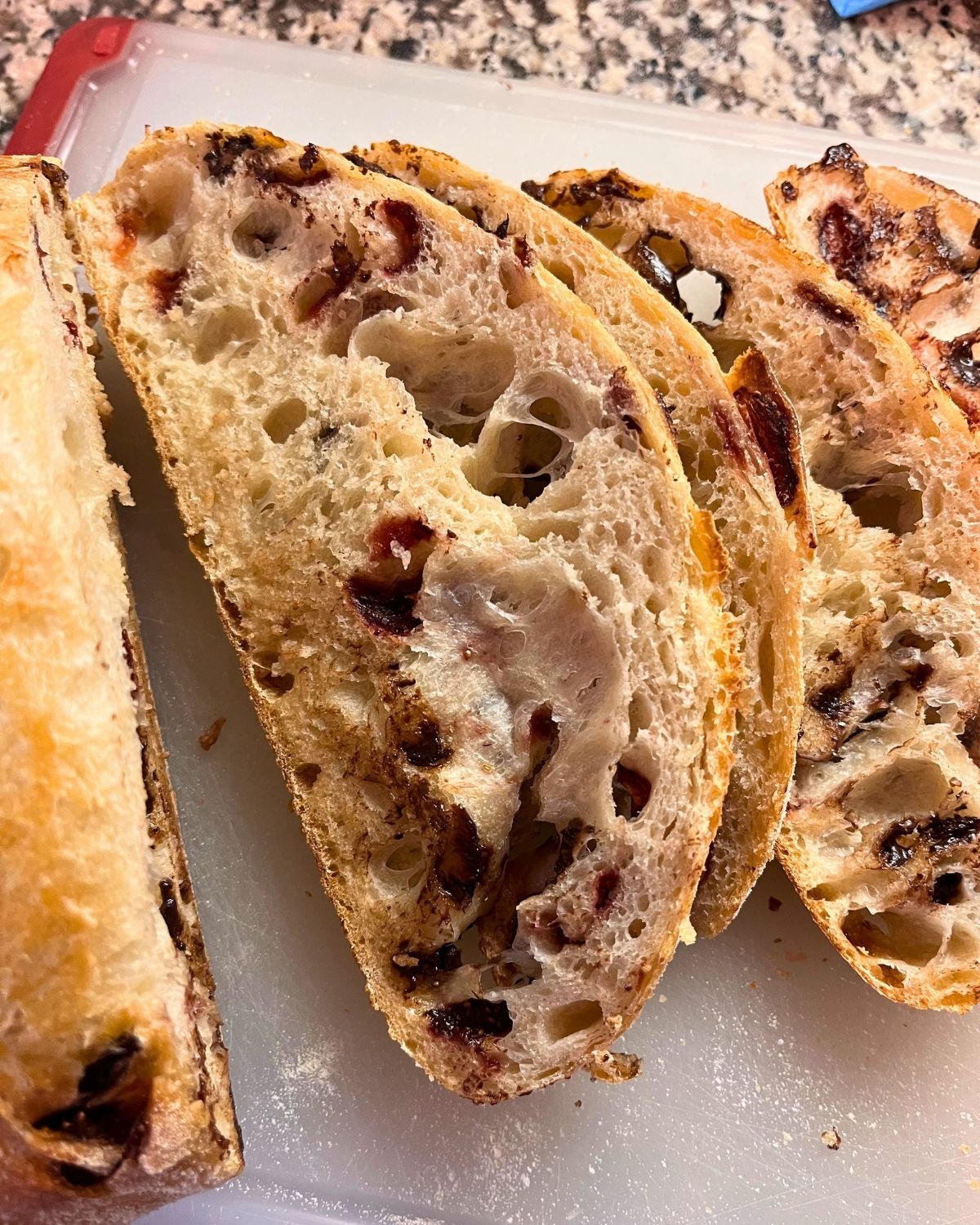 chocolate strawberry bread sliced on cutting board.