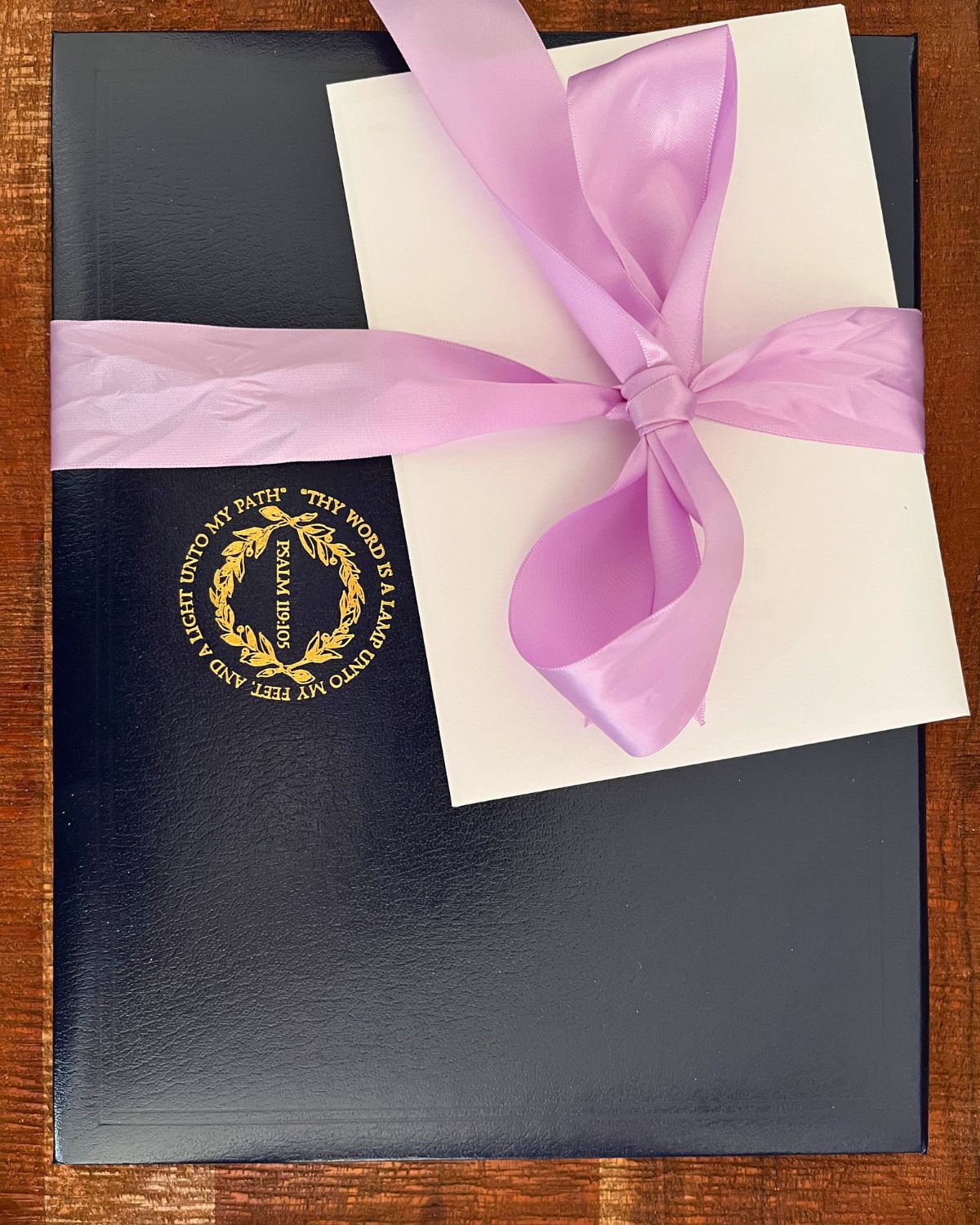 high school diploma with greeting card, tied with purple bow.
