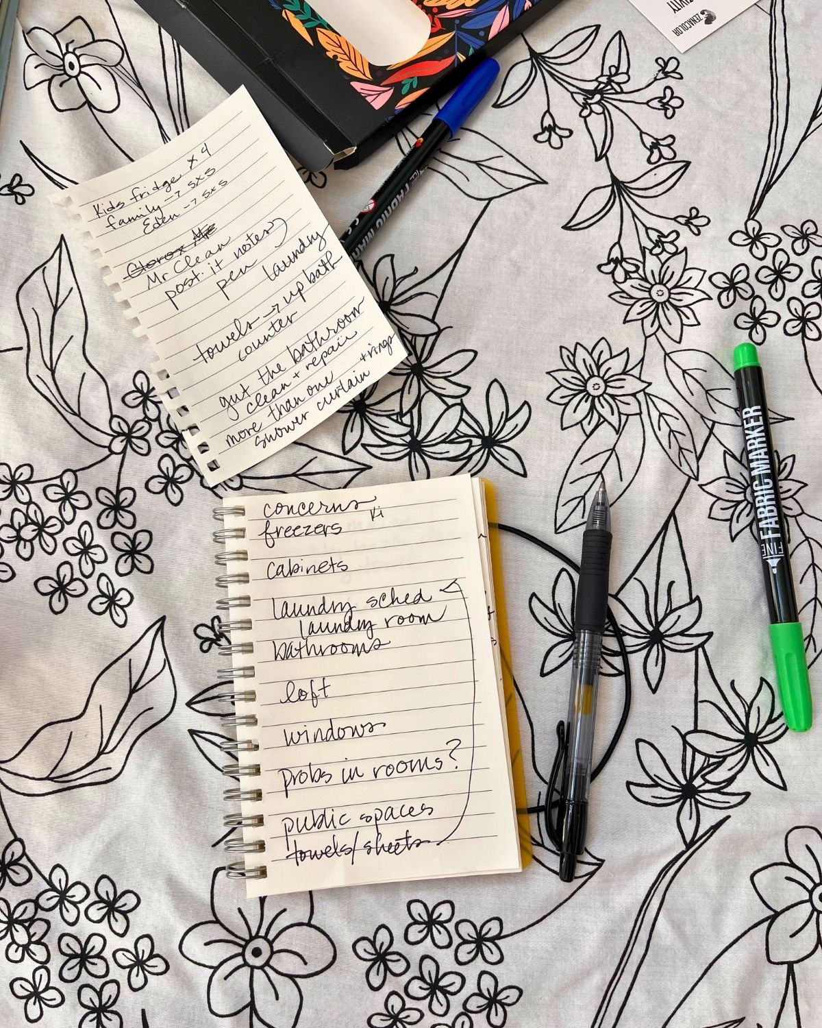 notes from housekeeping meeting on tablecloth with fabric pens.