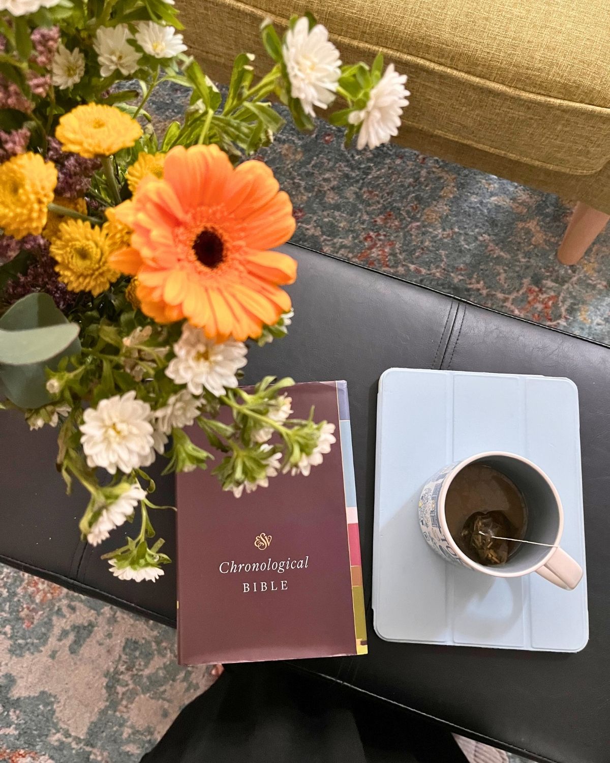 flowers, bible, and iPad with mug of tea.
