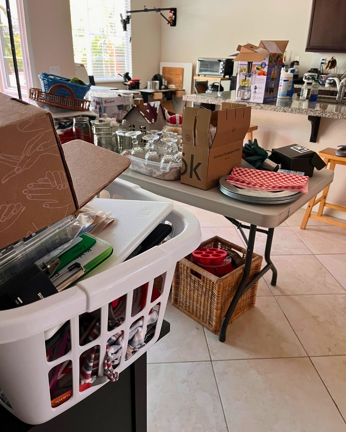 collection of stuff on tables, counters in kitchen.