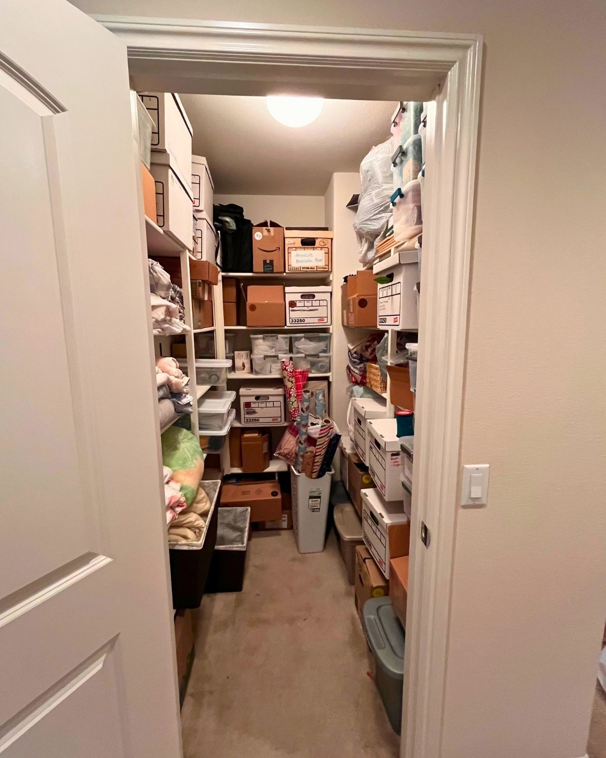 peek into hall closet with somewhat organized moving boxes.