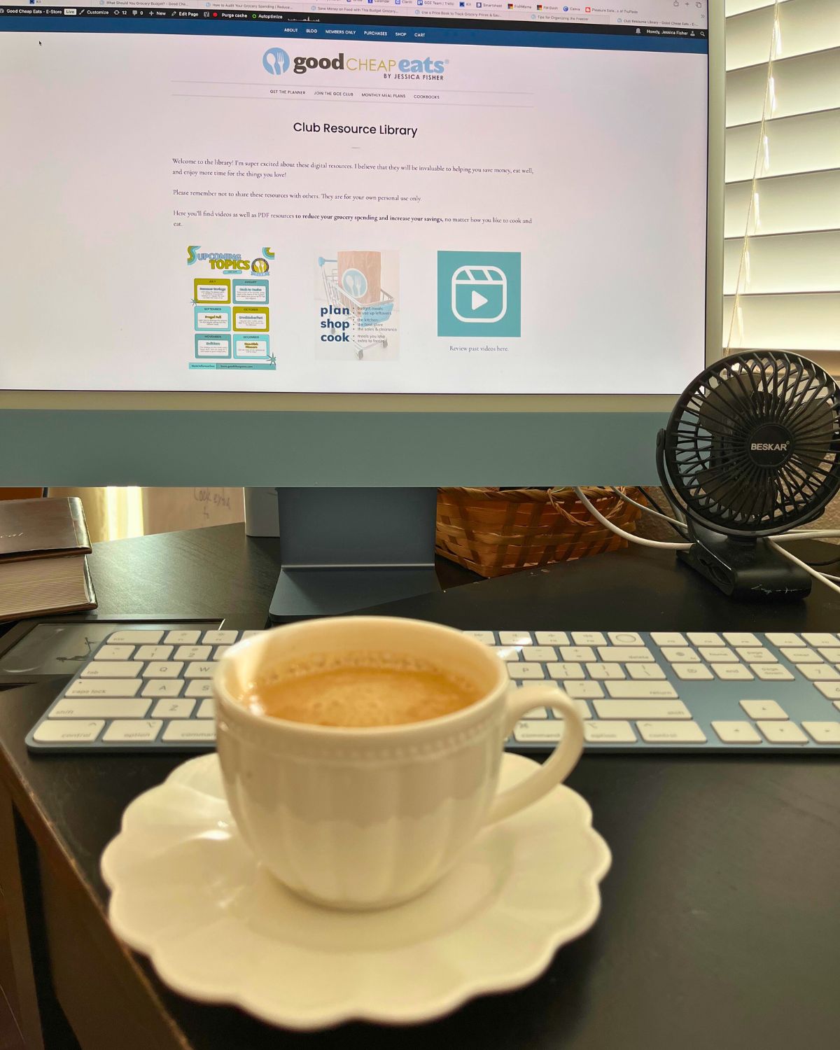 club library on computer screen with tea cup in front.