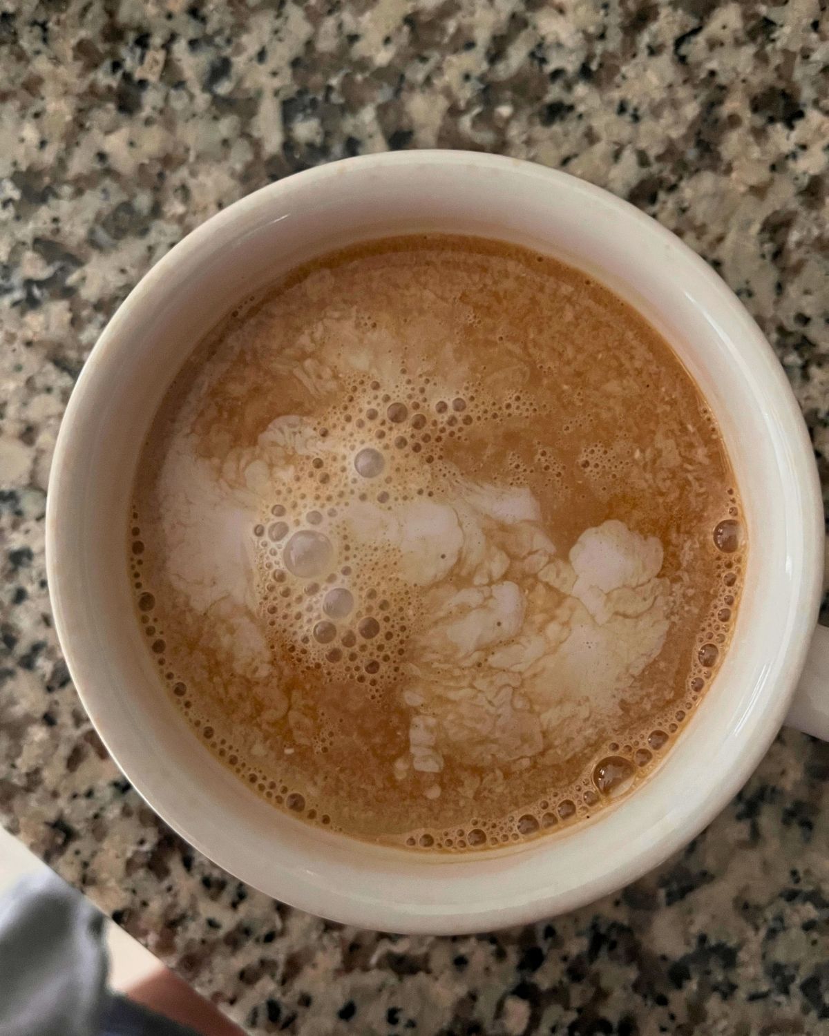 coffee cup with nut pods floating in the top.