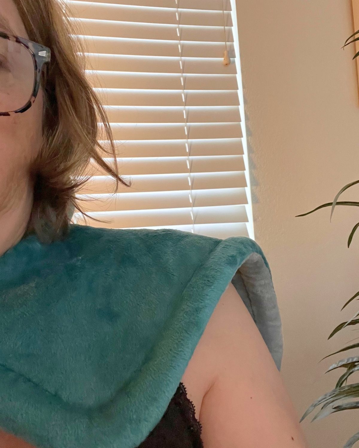 jessica wearing a heating pad cape.