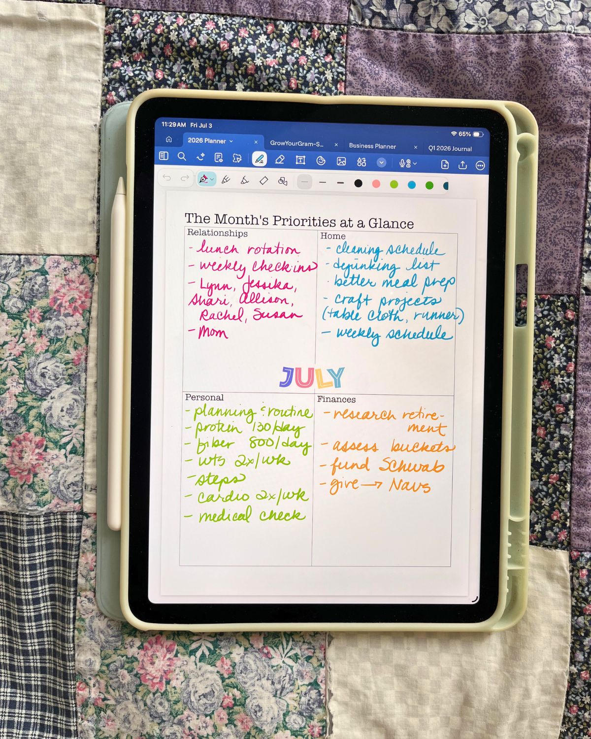 july planning page on iPad on quilt.