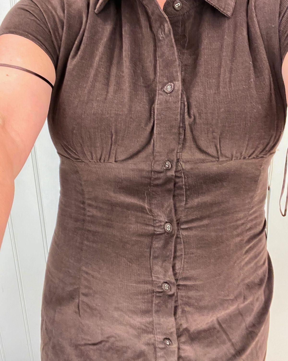 selfie of a brown dress that is too small.