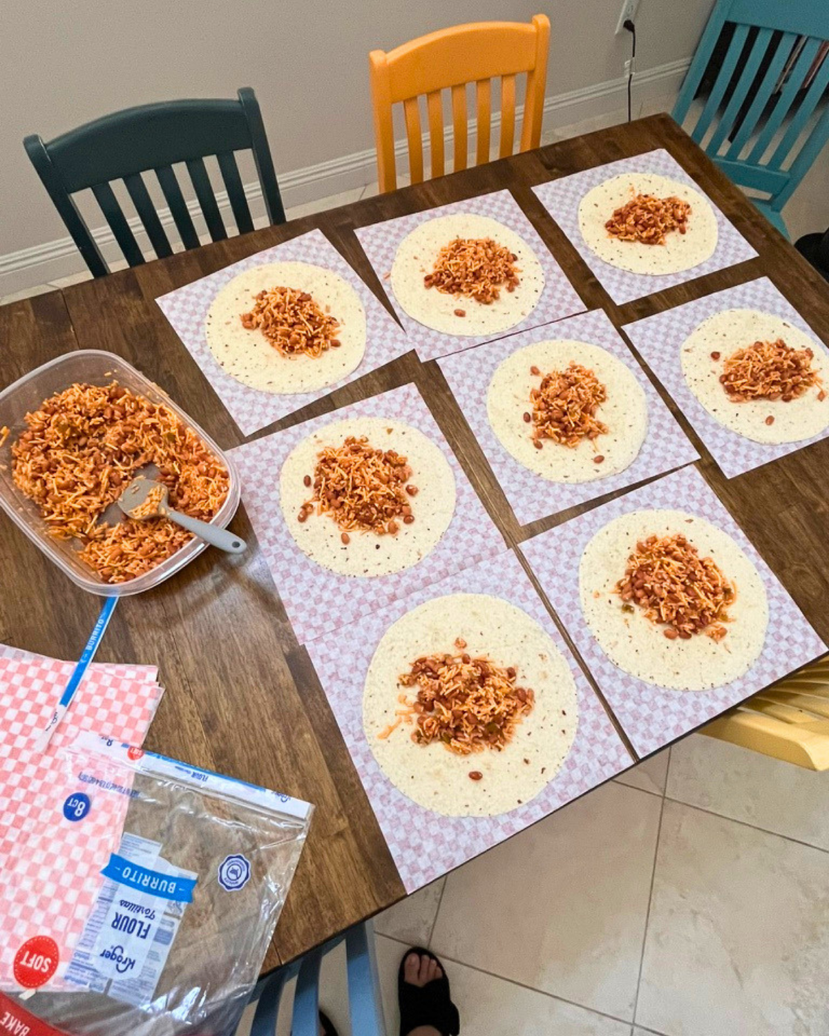 array of freezer burritos being made on table.