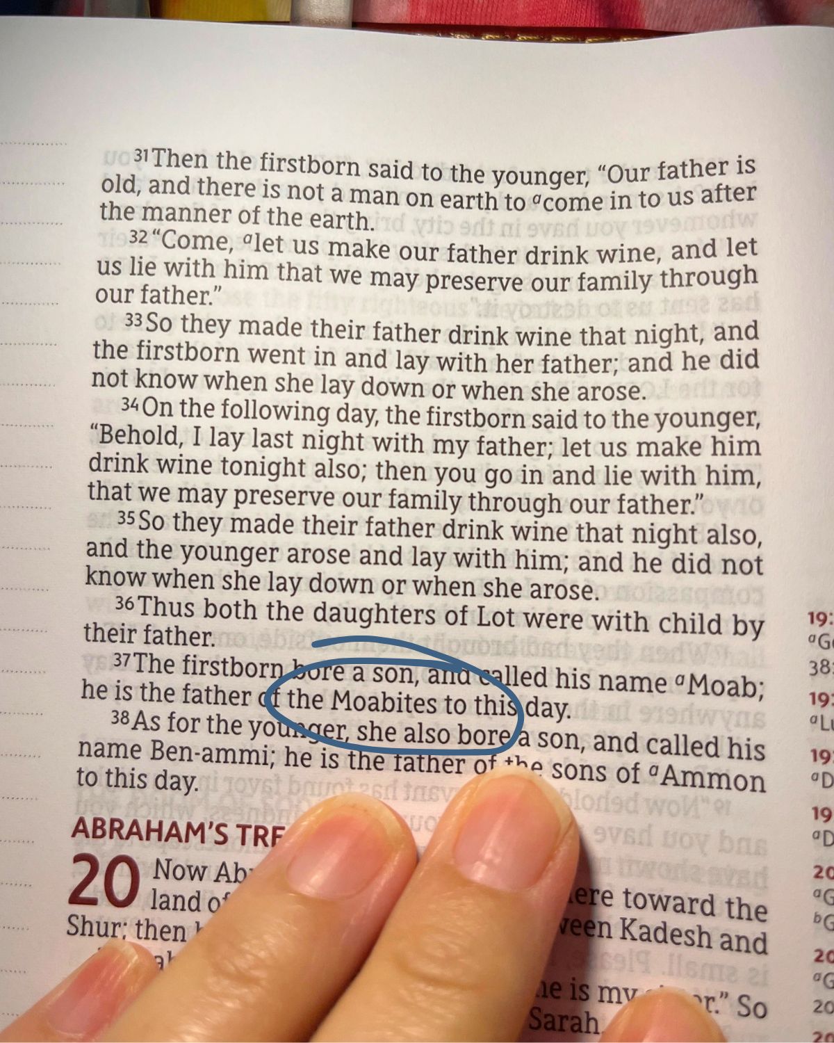 screenshot of genesis with hand holding the page, blue marking circling the word Moabites.