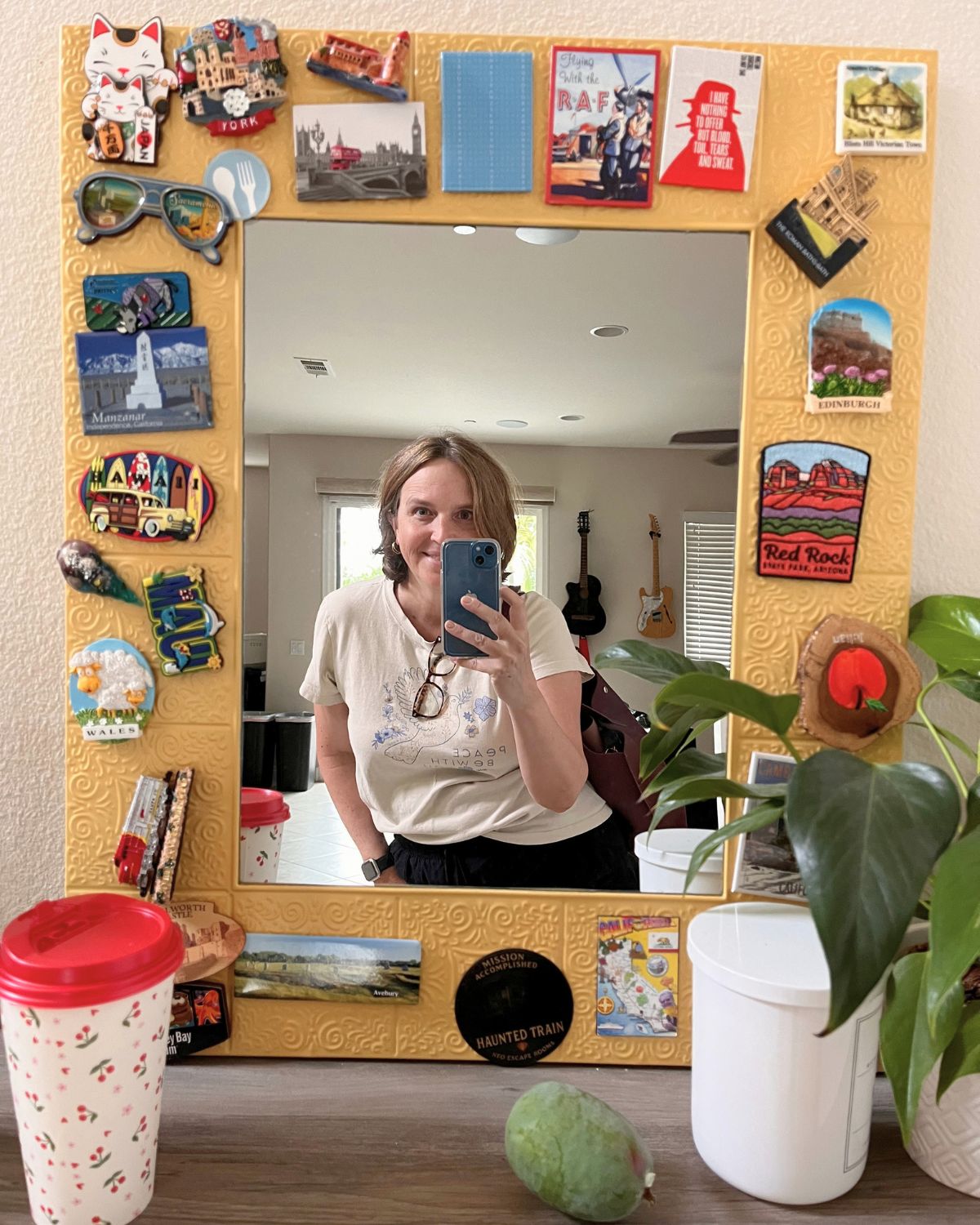 jessica in the magnet mirror with a coffee to go and a pineapple guava.