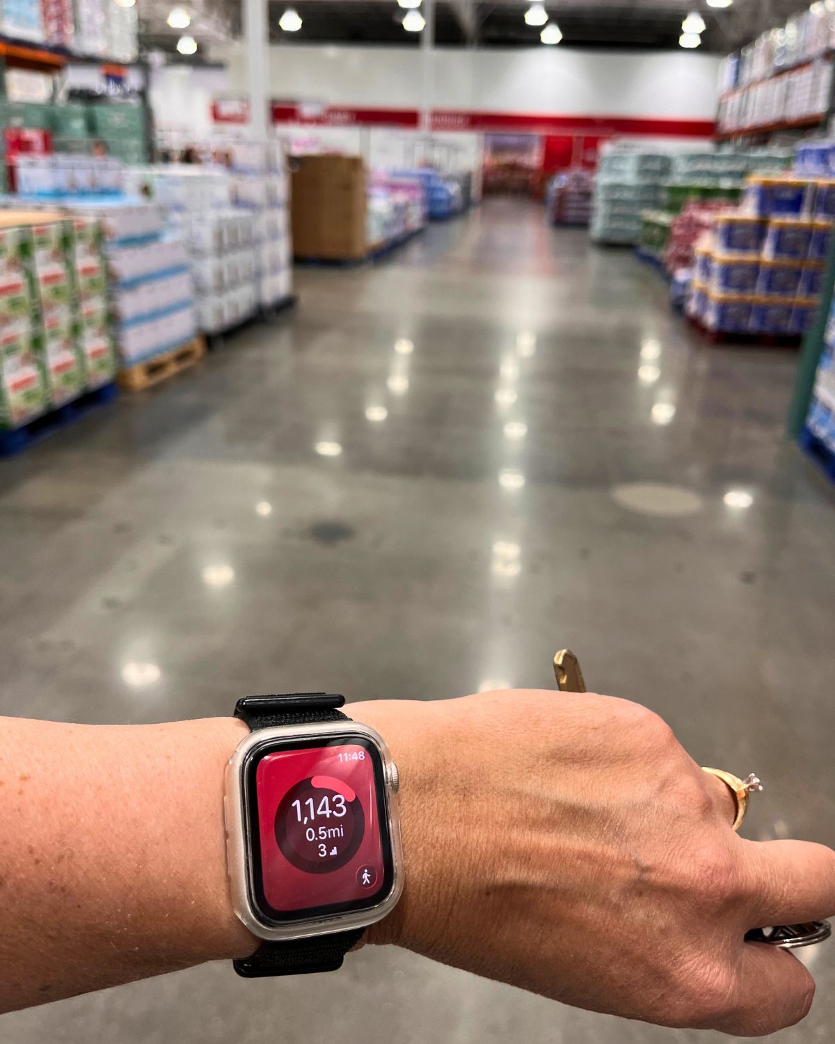 smart watch showing steps on wrist in costco.