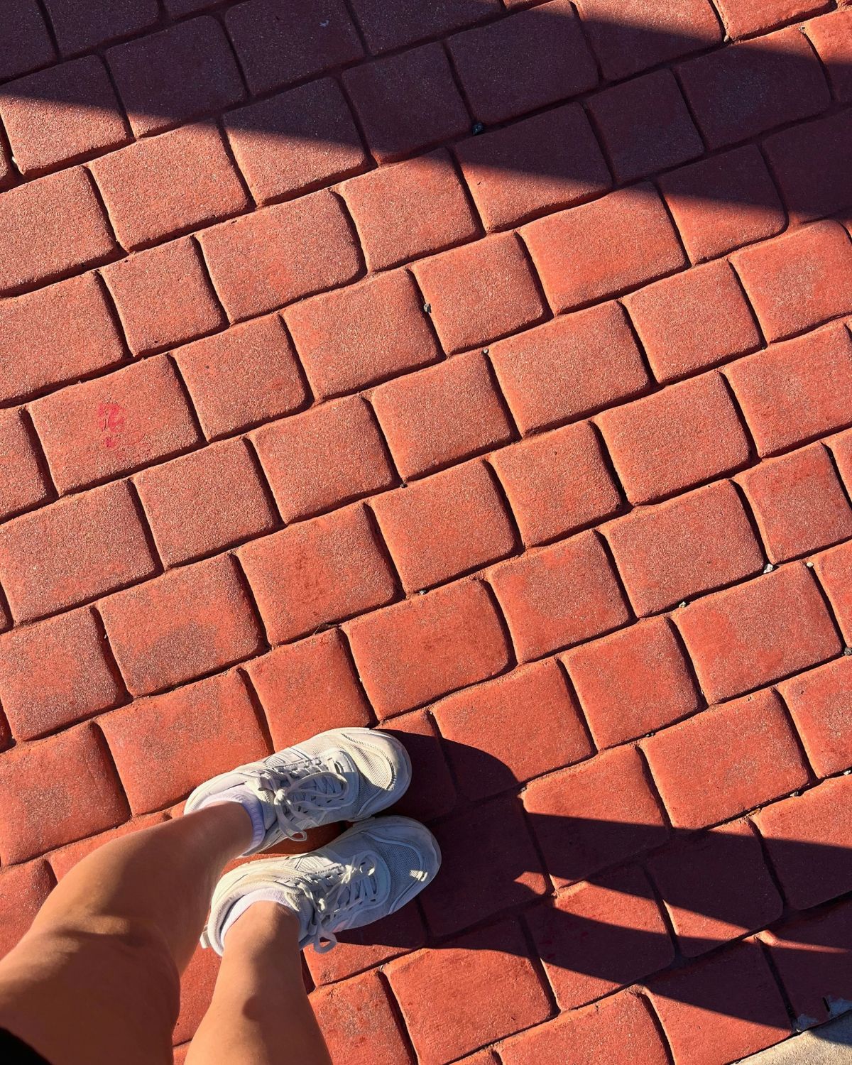 walking shoes on brick walkway.