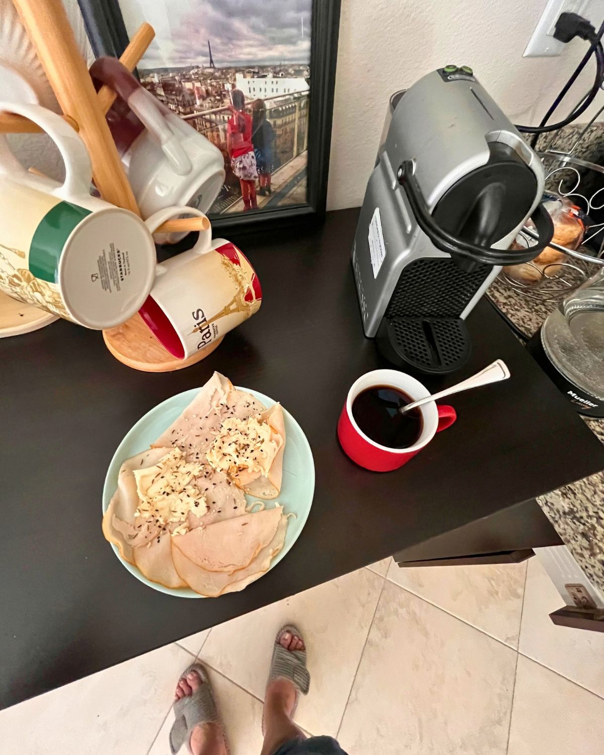 coffee station with a cup of coffee and a plate of turkey rolls ups.