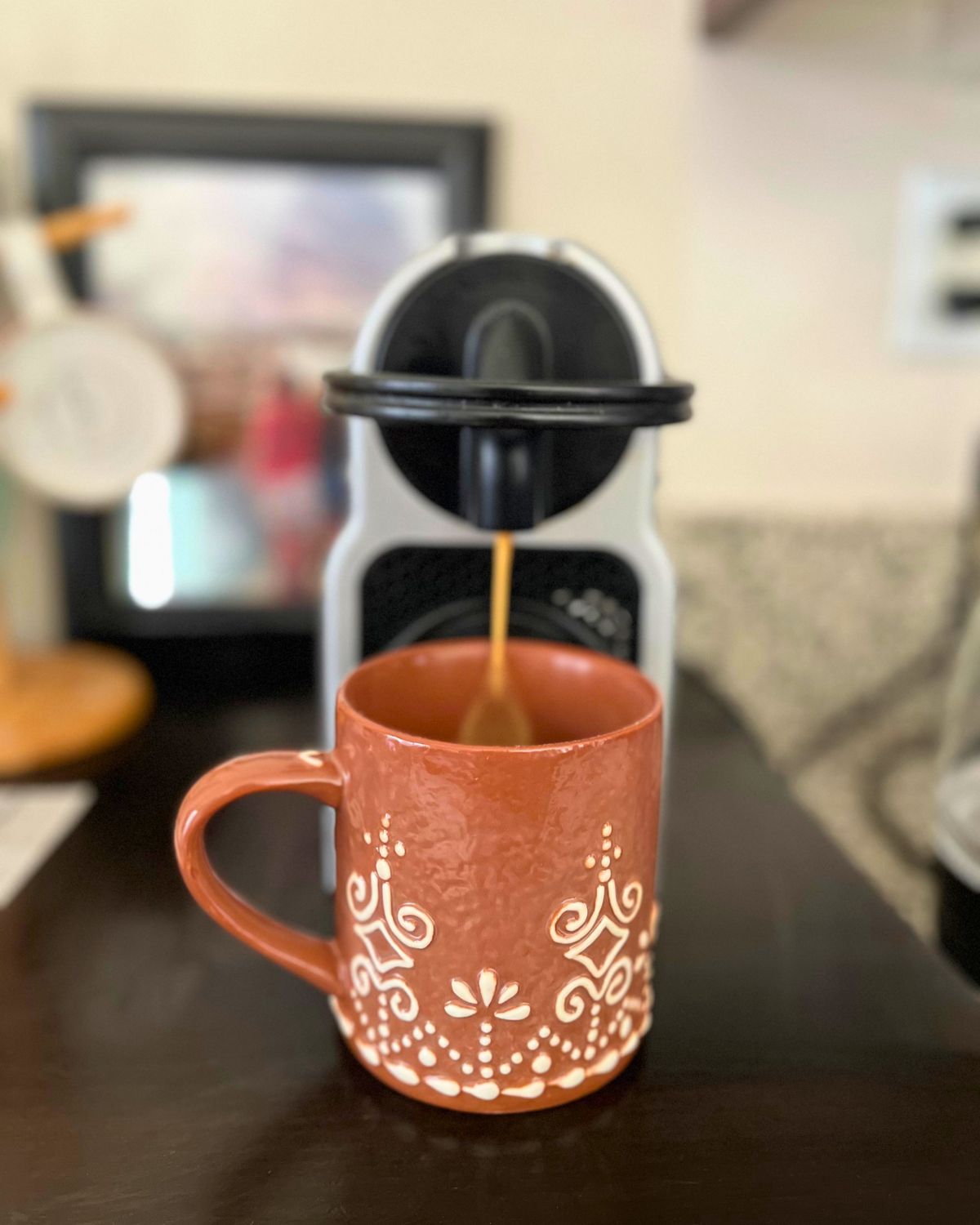 gingerbread mug under nespresso dispenser.